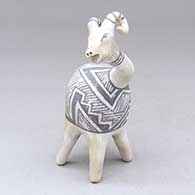 A black-on-white long-necked bighorn mountain sheep decorated with a geometric design
 by Michael Kanteena of Laguna