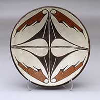 A shallow polychrome bowl decorated on the inside with a four-panel geometric design
 by Tomacita Toribio of Zia