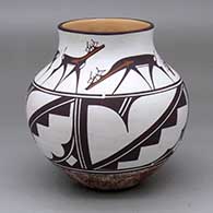 A polychrome jar decorated with a four-panel geometric design plus a band of deer-with-heart-line design
 by Agnes Peynetsa of Zuni