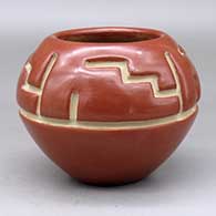A red bowl carved with a four panel geometric design above the shoulder
 by Margaret Tafoya of Santa Clara