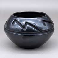 A black bowl carved above the shoulder with a four panel geometric design
 by Margaret Tafoya of Santa Clara