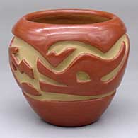 A red jar carved with an avanyu design around the body
 by Mary Cain of Santa Clara