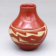 A small red jar carved with an avanyu design around the shoulder
 by Denise Chavarria of Santa Clara