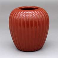 A red jar carved with a 32-rib melon design
 by Alvin Baca of Santa Clara