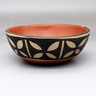 A polychrome bowl polished inside and decorated on the outside with an eight-panel butterfly and geometric design
 by Paulita Pacheco of Santo Domingo