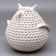 A corrugated white owl figure
 by Stella Shutiva of Acoma
