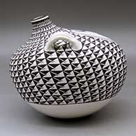 A large black on white canteen with handles and decorated with a crane and fish medallion surrounded by a spiral mesa geometric design, click or tap to see a larger version