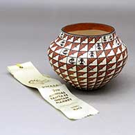 A polychrome jar decorated with a spiral mesa, kokopelli, pueblo dancer and geometric design
 by Wanda Aragon of Acoma