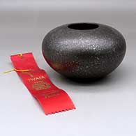 A black micaceous bowl, Second Place ribbon 2000 Santa Fe Indian Market
 by Preston Duwyenie of Hopi