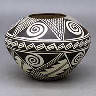 A black on white jar decorated with a five-point Awatovi star, spirals, crosshatching and geometric design
 by Amber Naha of Hopi