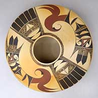 A polychrome low shoulder seed pot decorated above the shoulder with a two-panel bird element and geometric design
 by Karen Abeita of Hopi