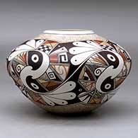 A polychrome bowl decorated with a five panel bird element and geometric design, click or tap to see a larger version
