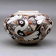 A polychrome bowl decorated with a five panel bird element and geometric design, click or tap to see a larger version