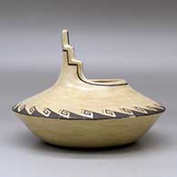 A black on brown jar with a kiva step cut rim ad decorated above the low shoulder with a corn stalk and geometric design, click or tap to see a larger version