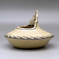 A black on brown jar with a kiva step cut rim ad decorated above the low shoulder with a corn stalk and geometric design, click or tap to see a larger version