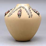 A polychrome jar decorated with five ear-of-corn appliques and a painted  five panel geometric design, click or tap to see a larger version