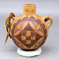 A black on mixed clay canteen with handles and decorated on two sides with a fineline and geometric design
 by Calvin Analla Jr of Laguna