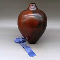 A tall brown shoulder jar with fire clouds, First Place ribbon from 1993 Santa Fe Indian Market
 by Alice Cling of Dineh