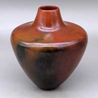 A high-shouldered brown jar decorated with fire clouds
 by Alice Cling of Dineh