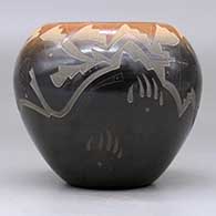 A black bowl with a sienna rim and decorated with a sgraffito avanyu and geometric design, click or tap to see a larger version