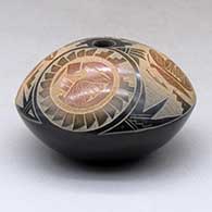 A black seed pot with sienna spots and a sgraffito medallion, kokopelli, yeibichai, butterfly and geometric design above the shoulder, click or tap to see a larger version