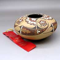 A polychrome seed pot decorated above the shoulder with a four panel turtle and geometric design, Second Prize ribbon 1983 Santa Fe Indian Market
 by Lois Gutierrez of Santa Clara