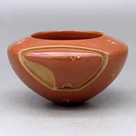 Click for a larger view A red bowl carved with a bear design and sgraffito heart line and with sgraffito bear paws around the body
by Effie Garcia of Santa Clara