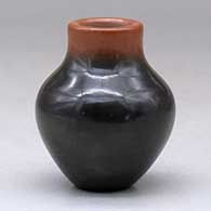 A miniature two-tone jar with an inlaid stone, click or tap to see a larger version