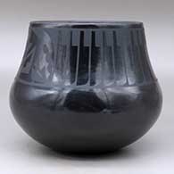 A black on black jar decorated with a band of feathers and geometric design above the shoulder, plus an inlaid stone, click or tap to see a larger version