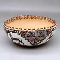 A polychrome bowl decorated around the outside with a deer-with-heart-line and geometric design, and around the inside with a row of tiny frog appliques along the rim and three frog appliques in the bottom
 by Noreen Simplicio of Zuni