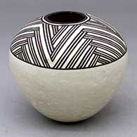 A black-on-white seed pot decorated above the shoulder with a four-panel fine line rock art geometric design
 by Lucy Lewis of Acoma