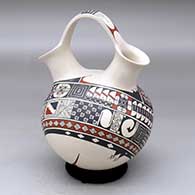 A polychrome wedding vase decorated with a two-panel geometric design
 by Ismael Flores Jr of Mata Ortiz and Casas Grandes