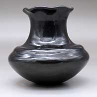 A double-shouldered black jar with a tall neck and pie crust rim, click or tap to see a larger version