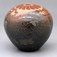 A two-tone seed pot decorated with a sgraffito hummingbird, flower, plants, feathers and geometric design, click or tap to see a larger version