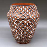 A tall polychrome jar decorated with a stylized checkerboard and basketweave geometric design
 by Virginia Stevens of Acoma