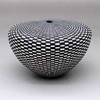 A black-on-white flat-topped seed pot decorated with a checkerboard geometric design
 by Sandra Victorino of Acoma