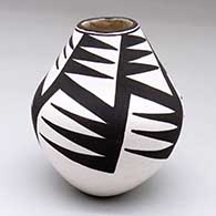 A black-on-white jar decorated with a five-panel geometric design
 by Dolores Lewis of Acoma