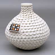 A corrugated white water jar with polychrome geometric designs on the handles
 by Stella Shutiva of Acoma