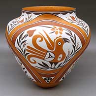A large, high-shouldered polychrome jar decorated with a four-panel parrot, rainbow, plant, flower and geometric design
 by Loretta Joe of Acoma