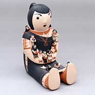 A sitting grandmother storyteller figure holding thirteen children
 by Dena Suina of Cochiti