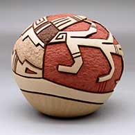 A carved and painted polychrome seed pot decorated with a pueblo dancer, corn stalk and geometric design, click or tap to see a larger version