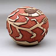 A carved and painted polychrome seed pot decorated with a pueblo dancer, corn stalk and geometric design, click or tap to see a larger version