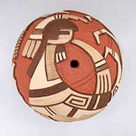 A carved and painted polychrome seed pot decorated with a pueblo dancer, corn stalk and geometric design
 by Thomas Polacca of Hopi
