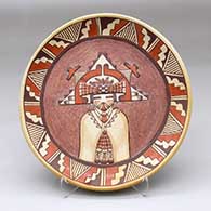 A polychrome plate carved and painted with a Palik Mana and geometric design
 by Eloy Navasie of Hopi