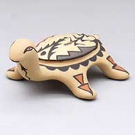 A small polychrome turtle figure decorated with a cornstalk and geometric design
 by Juanita Fragua of Jemez