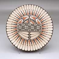 A polychrome plate decorated with a ring-of-feathers around a medallion with geometric designs
 by Rachel Sandia of Jemez