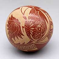 A red seed pot decorated with a sgraffito butterfly, flower and geometric design
 by Vangie Tafoya of Jemez