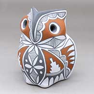 A polychrome owl figure decorated with fine line, bird element and geometric design
 by Mary Small of Jemez