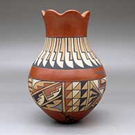 A polychrome vase with a scalloped rim and decorated with a band-of-feathers and geometric design, click or tap to see a larger version