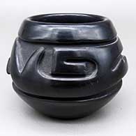 Small black jar with a carved geometric design
 by Stella Chavarria of Santa Clara
